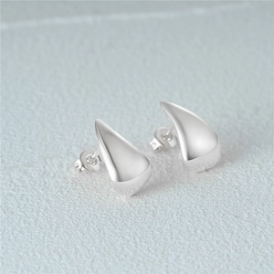 Macro shot of 925 silver C-shape stud earrings with a polished metallic finish