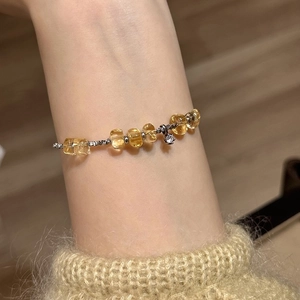 Zircon silver and yellow citrine beaded bracelet on wrist with elegant diamond charm