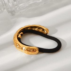 Hammered texture 18K gold stainless steel hair cuff with black elastic band on white background