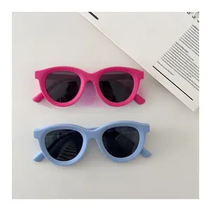 Close-up of pink and light blue kids' polarized sunglasses with soft matte silicone frames