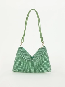 Detailed view of emerald green rhinestone evening bag with knotted crystal handle and satin lining
