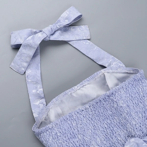 Detail of lavender halter dress showing bow-tie neck and ruched jacquard fabric texture