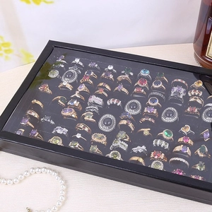 Black jewelry box with 100 slots for rings and earrings featuring a clear lid and pearls