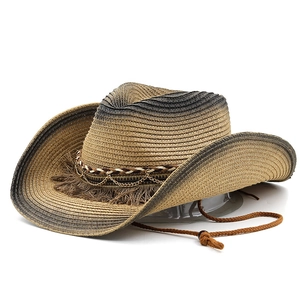 Detail of straw cowboy hat featuring gradient weave, metal chain and tassel trim