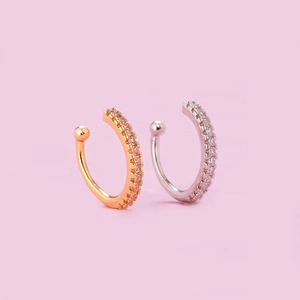 Detail view of gold and silver ear cuffs with micro-paved cubic zirconia stones