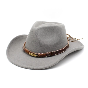 Detail of dark gray wool cowboy hat featuring a braided band and gold feather pendant