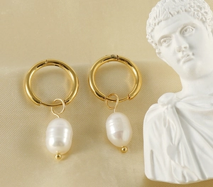 Detail view of 18K gold stainless steel hoop earrings with natural freshwater pearls