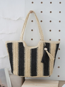 Minimalist black and white striped straw shoulder tote bag with decorative fringe tassels