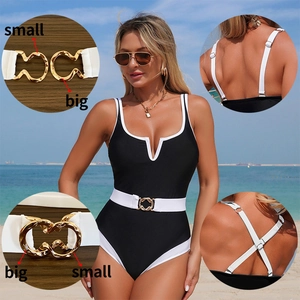 Chic black and white one-piece swimsuit with U-neck and belted gold ring buckle detail