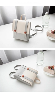 Detailed views of a minimalist two-tone cream and grey small square backpack for women
