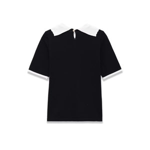 Back view of black short-sleeve knit top with white Peter Pan collar and button detail