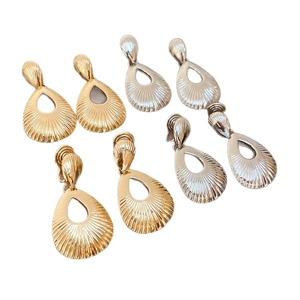 Textured hollow teardrop metal earrings in gold and silver finish with radial patterns