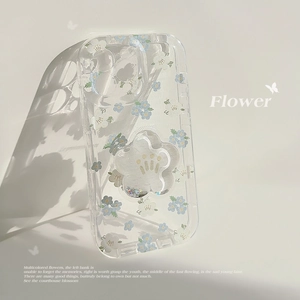 Close-up of floral iPhone case with blue flowers and a liquid glitter flower phone stand