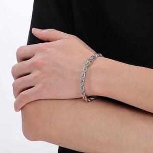 Close-up of a silver stainless steel rope chain bracelet worn on a male wrist