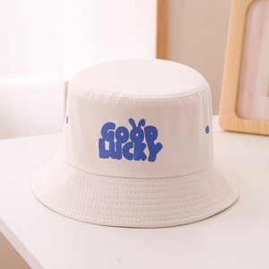 Detail of beige cotton bucket hat for kids with blue GOOD LUCKY lettering and bunny ears