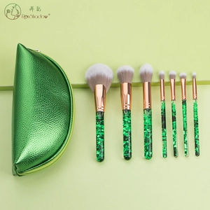Green glitter handle makeup brush set with matching semi-circle zipper storage pouch