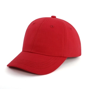 Close-up of red cotton twill baseball cap showing six-panel stitch and curved brim