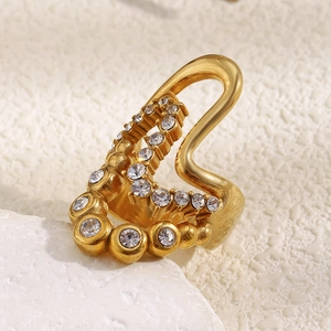 Close-up of 18K gold plated multi-layer wave ring with cubic zirconia on stone base