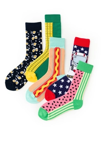 Flat lay of colorful cotton crew socks featuring beer, corn, hot dog, and astronaut patterns