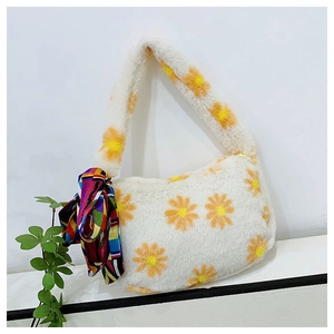 Detailed texture of white plush tote bag featuring yellow daisy patterns and silk scarf handle