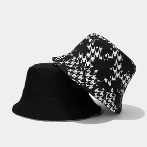 Detail view of cotton bucket hats with pixelated houndstooth pattern and reinforced brim