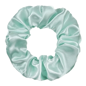 Detailed texture of light mint green satin scrunchie showing glossy fabric folds