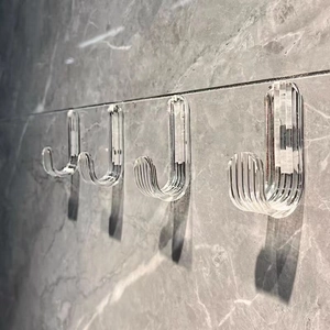 Strong transparent adhesive wall hooks with vertical stripe texture on marble surface