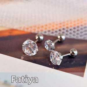 Macro shot of three stainless steel stud earrings featuring clear round cubic zirconia stones