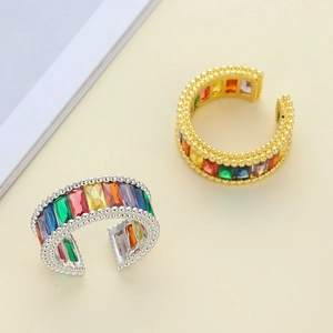 Macro shot of adjustable rainbow zircon ring with milgrain edge in gold and silver finish
