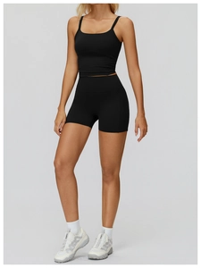 Close-up of black high-waist yoga shorts with ruched details and professional gym wear fabric