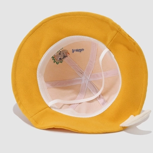 Detail of yellow kids bucket hat showing interior cotton lining, stitching and hello embroidery