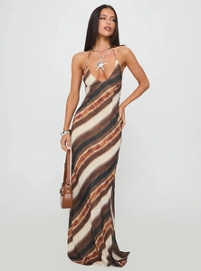 Detail of a tie-dye maxi dress featuring thin straps and lightweight draping fabric