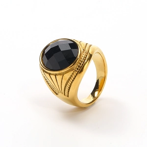 Vintage gold ring with multifaceted black gemstone and ornate twisted texture design