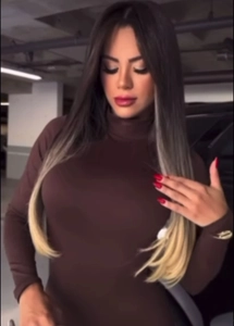 Detailed view of the dark brown high-neck long sleeve slim fit dress on a model