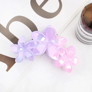 Detailed view of flower hair claw clip with purple and pink gradient pearl finish