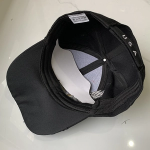 Detail view of cotton baseball cap interior with 100% cotton tag and USA embroidery