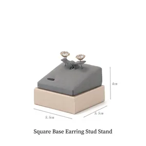 Detail view of a 5.5cm square gray microfiber stud earring display stand with base