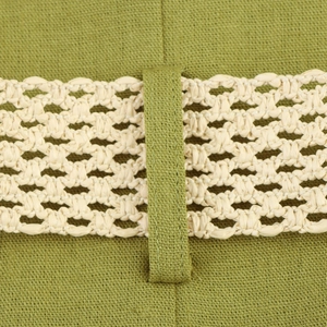 Close-up detail of olive green linen fabric and beige woven decorative belt on the waist