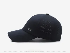 Close-up of laser-cut ventilation holes and YS logo on navy mesh baseball cap