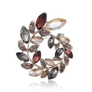 Elegant crystal olive branch wreath brooch with sparkling red and champagne stones