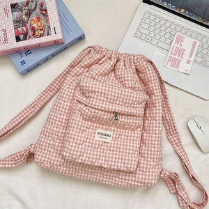 Detail of pink plaid quilted drawstring backpack with heart embroidery and brand label