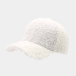 Close-up of white plush baseball cap showing warm faux fur texture and minimalist design