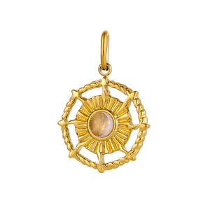 Macro detail of round stainless steel pendant with solar pattern and yellow gemstone