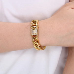 Close-up of golden Cuban link bracelet with iced-out square buckle worn on wrist