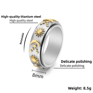 Detail of 8mm rotating titanium ring with gold sun moon star relief on silver band