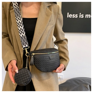 Detail of black woven chest bag with matching round coin purse and geometric strap