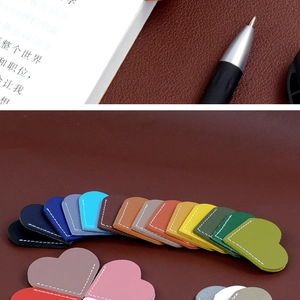 Close-up of heart-shaped PU leather bookmarks with durable white contrast stitching