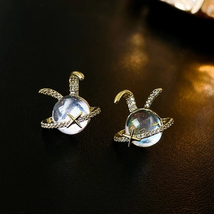 Detail of gold-plated rabbit planet stud earrings with resin stones and zircon star ring