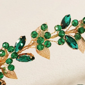 Macro detail of gold leaf wire headband with emerald green crystals and pearls