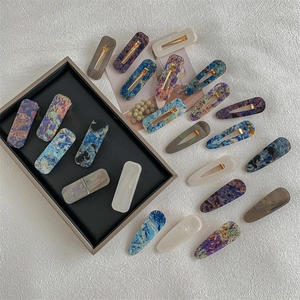 Set of resin geometric hair clips with marble texture in rectangular and teardrop shapes